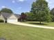 Charming single-story home with a well-manicured lawn and long driveway at 105 Carols Ln, Locust Grove, GA 30248