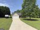 Attractive one-story home with a well-manicured lawn, attached garage, and RV parking at 105 Carols Ln, Locust Grove, GA 30248