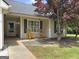 Inviting front porch with two rocking chairs and well-maintained landscaping offering a relaxing outdoor space at 105 Carols Ln, Locust Grove, GA 30248