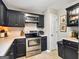 Kitchen features black cabinetry, stainless steel appliances, and ample countertop space at 105 Carols Ln, Locust Grove, GA 30248