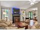 Cozy living room featuring a fireplace, plush sofa, and open access to the dining area at 105 Carols Ln, Locust Grove, GA 30248