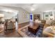 Open-concept living room featuring comfortable seating, hardwood floors, and access to other areas of the house at 105 Carols Ln, Locust Grove, GA 30248