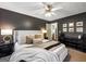 Comfortable main bedroom featuring stylish decor, dark accent walls, and plush bedding at 105 Carols Ln, Locust Grove, GA 30248