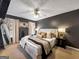 Spacious primary bedroom featuring a decorative accent wall, plush bedding, and ample natural light at 105 Carols Ln, Locust Grove, GA 30248