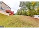 Expansive backyard offering lush greenery, mature trees, and a storage shed at 1373 Fall River Dr, Conyers, GA 30013