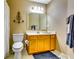 Bathroom with a classic vanity, well-placed lighting, and essential fixtures like the toilet and sink at 1373 Fall River Dr, Conyers, GA 30013