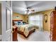 A bedroom with a ceiling fan features a bed with plush bedding, and natural light from a window at 1373 Fall River Dr, Conyers, GA 30013