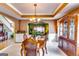 Charming dining room with hardwood floors, a stylish chandelier, and views into the living room at 1373 Fall River Dr, Conyers, GA 30013