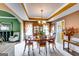 Elegant dining room featuring a tray ceiling, a chandelier, and an open layout to other living areas at 1373 Fall River Dr, Conyers, GA 30013