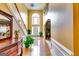 Elegant foyer with hardwood floors, a staircase, and a large window bringing in natural light at 1373 Fall River Dr, Conyers, GA 30013