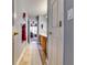 Inviting hallway featuring neutral walls, tile flooring, and doors, with a glimpse into the rooms beyond at 1373 Fall River Dr, Conyers, GA 30013