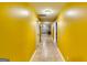 Hallway features warm yellow walls and tiled floors, leading to various rooms at 1373 Fall River Dr, Conyers, GA 30013