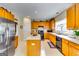 Spacious kitchen with stainless steel appliances, wooden cabinets, and a center island with a white countertop at 1373 Fall River Dr, Conyers, GA 30013