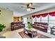 Spacious living room with plush seating, elegant curtains, and seamless flow to the kitchen area at 1373 Fall River Dr, Conyers, GA 30013