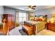 Comfortable main bedroom with a detailed bed frame, wooden storage chest, and soft window treatments at 1373 Fall River Dr, Conyers, GA 30013