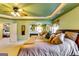 Spacious main bedroom featuring plush bedding, a ceiling fan, and a cozy fireplace in the attached seating area at 1373 Fall River Dr, Conyers, GA 30013