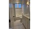 Well-lit bathroom featuring white tiled walls, a shower-tub combo and a sleek vanity with marble countertop at 10583 Serenbe Ln, Palmetto, GA 30268