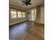 Bedroom featuring hardwood floors, natural lighting and backyard views at 10583 Serenbe Ln, Palmetto, GA 30268