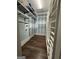 Walk-in closet with custom shelving and hardwood floors at 10583 Serenbe Ln, Palmetto, GA 30268