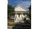 Charming two-story home with a large front porch, white siding and beautiful landscaping at 10583 Serenbe Ln, Palmetto, GA 30268