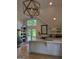 Bright kitchen with marble island, modern appliances, and access to outdoor area at 10583 Serenbe Ln, Palmetto, GA 30268