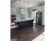 Eat-in kitchen with stainless steel appliances, a large island, pendant lights, and white cabinetry at 10583 Serenbe Ln, Palmetto, GA 30268