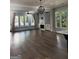 Open living room with hardwood floors, fireplace, built-in shelves, and an abundance of natural light at 10583 Serenbe Ln, Palmetto, GA 30268