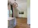 Bright open space with a modern geometric pendant light, light hardwood flooring and a marble-topped island at 10583 Serenbe Ln, Palmetto, GA 30268