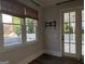 Sunlit room with hardwood floors, TV mount, and access to outdoor space at 10583 Serenbe Ln, Palmetto, GA 30268