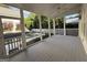 Spacious screened porch with wood flooring overlooking backyard pool and landscaping at 10583 Serenbe Ln, Palmetto, GA 30268