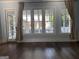 Sun room with hardwood floors, recessed lighting, and exterior views through large windows at 10583 Serenbe Ln, Palmetto, GA 30268