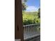 Scenic view from the balcony overlooking lush greenery and foliage under a bright blue sky at 10583 Serenbe Ln, Palmetto, GA 30268