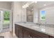 Bright bathroom featuring a double vanity with granite countertop, large mirror, and a shower at 123 Oak Road, Locust Grove, GA 30248