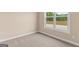Carpeted bedroom with large window and neutral walls allowing lots of light in the room at 123 Oak Road, Locust Grove, GA 30248