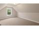 Bedroom with neutral walls and carpet, a bright window offering a view of surrounding greenery at 123 Oak Road, Locust Grove, GA 30248