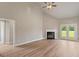 Spacious living room featuring hardwood floors, a modern fireplace, and natural light at 123 Oak Road, Locust Grove, GA 30248