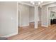 Open-concept space with hardwood floors, white trim, and contemporary lighting at 123 Oak Road, Locust Grove, GA 30248