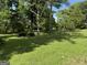 Picture of a clearing in the front yard with grass and trees at 3136 Camp Branch Rd, Buford, GA 30519