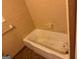 Bathroom featuring a white bath tub and tan tile walls at 4720 Ben Hill Rd, South Fulton, GA 30349