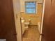 Bathroom with tile floor, tan tile walls, and shower/bath combo at 4720 Ben Hill Rd, South Fulton, GA 30349