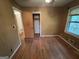 Bedroom featuring wood paneled walls and hardwood floors at 4720 Ben Hill Rd, South Fulton, GA 30349