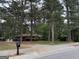 Charming brick home nestled among mature trees, offering privacy and a serene setting at 4720 Ben Hill Rd, South Fulton, GA 30349