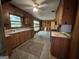 Kitchen with tile flooring, wood cabinetry, vintage stove, and view into dining room at 4720 Ben Hill Rd, South Fulton, GA 30349
