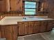 Kitchen sink with tile countertop and wood cabinets at 4720 Ben Hill Rd, South Fulton, GA 30349