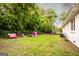 Spacious backyard with lush green grass, mature trees, playhouse, and privacy fence at 361 N Dogwood Ave, Social Circle, GA 30025