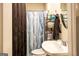 Bathroom with sink and toilet with decorative shower curtain at 361 N Dogwood Ave, Social Circle, GA 30025