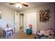 Neutral-toned bedroom with closet and playful decor at 361 N Dogwood Ave, Social Circle, GA 30025