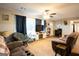 Spacious living room featuring a comfortable couch, a ceiling fan, and natural light at 361 N Dogwood Ave, Social Circle, GA 30025