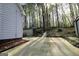 View of the backyard featuring a wooded lot and large concrete patio, offering a private outdoor space at 142 Kylee Ct, Villa Rica, GA 30180