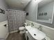 Bathroom featuring a unique sink, decorative shower curtain, and gray walls at 142 Kylee Ct, Villa Rica, GA 30180